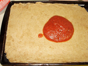 Delicious pizza begins with a delicious crust. You'll love this Sourdough Pizza Crust! Top with your favorite ingredients for pizza night at home. Tasty and frugal. | HomespunOasis.com